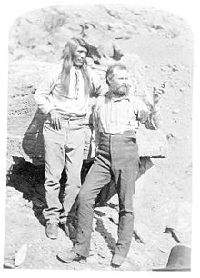 John Wesley Powell hiding his amputated right arm behind his Paiute messenger Tau-gu